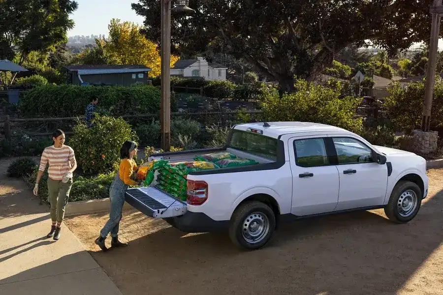 2022 Ford Maverick Performance - 1,500 Lbs. Max Payload 2 ladies loading fertilizer into the bed of a Maverick