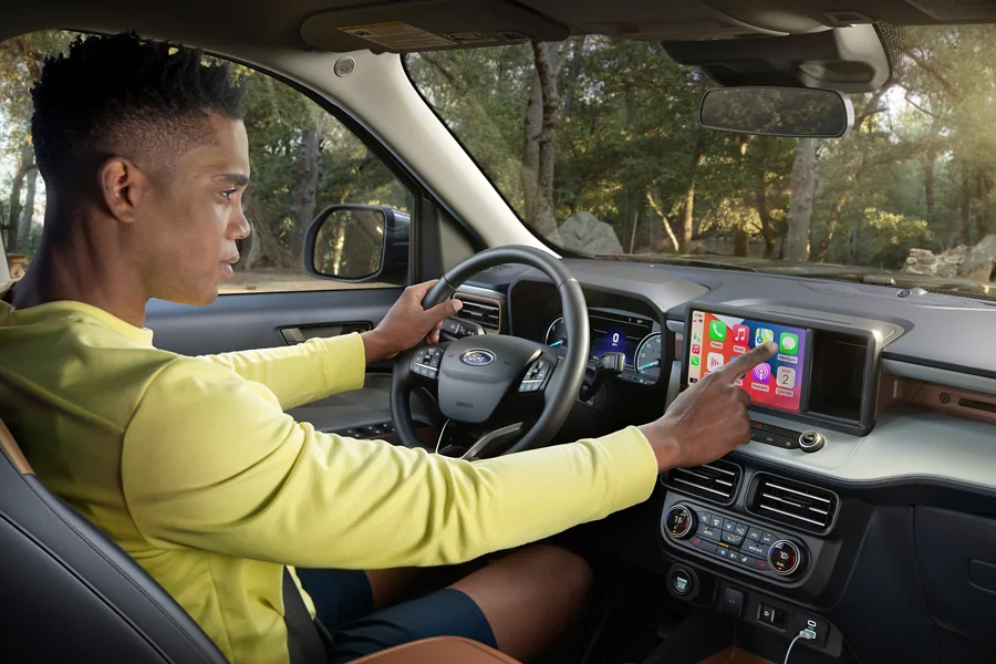 2022 Ford Maverick Technology - Apple CarPlay And Android Auto Compatibility Man in Maverick using AppleCarPlay