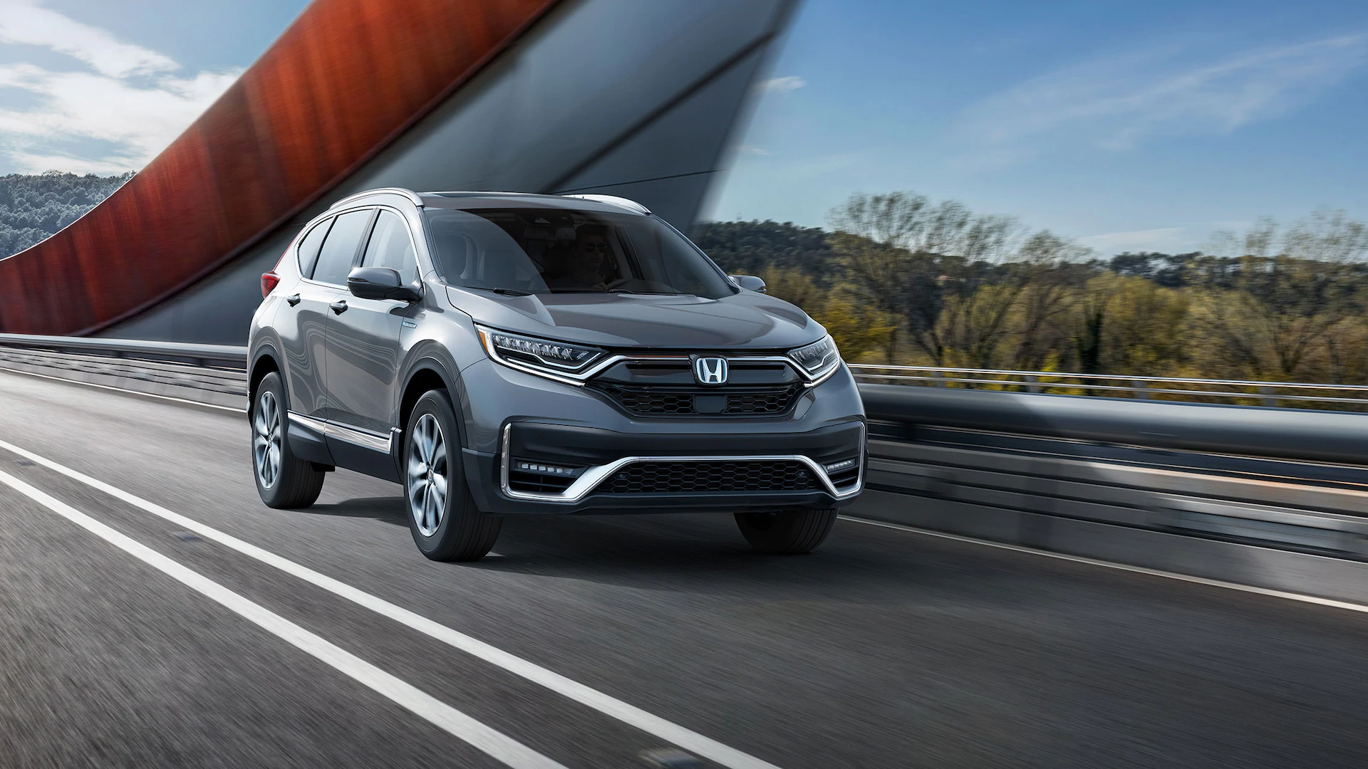 2021 Honda CR-V Exterior CR-V driving across bridge with view of the passaenger side