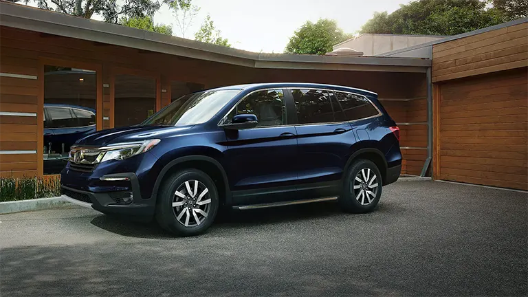2021 Honda Pilot Exterior Pilot sitting in front of modern garage