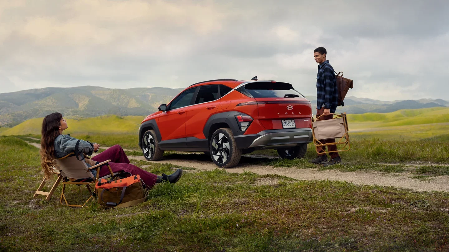 2024 Hyundai Kona - Design 2024 Hyundai Kona parked on dirt road with people around it