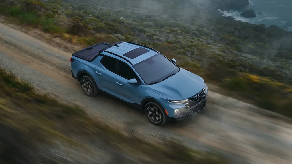 2024 Hyundai Santa Cruz - Design 2024 Hyudai Santa Cruz driving down seaside road