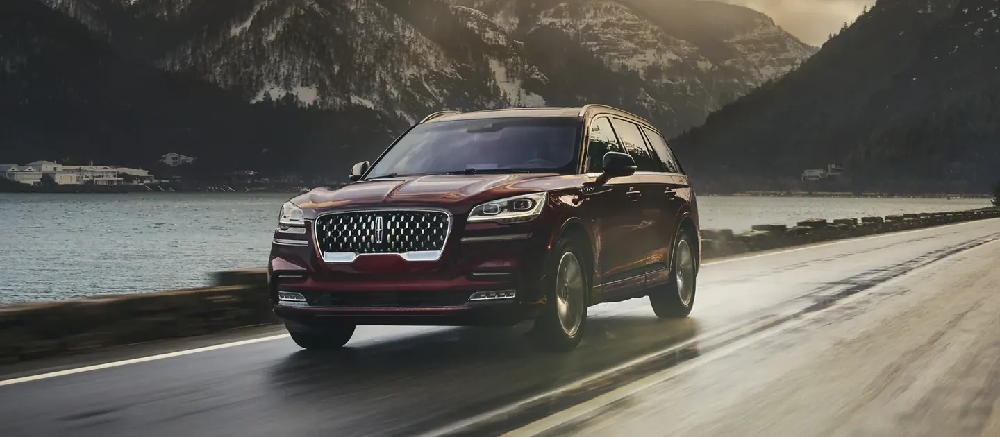 2022 Lincoln Aviator - Safety, near me in Englewood, NJ Aviator driving on highway next to a lake with mountains in background
