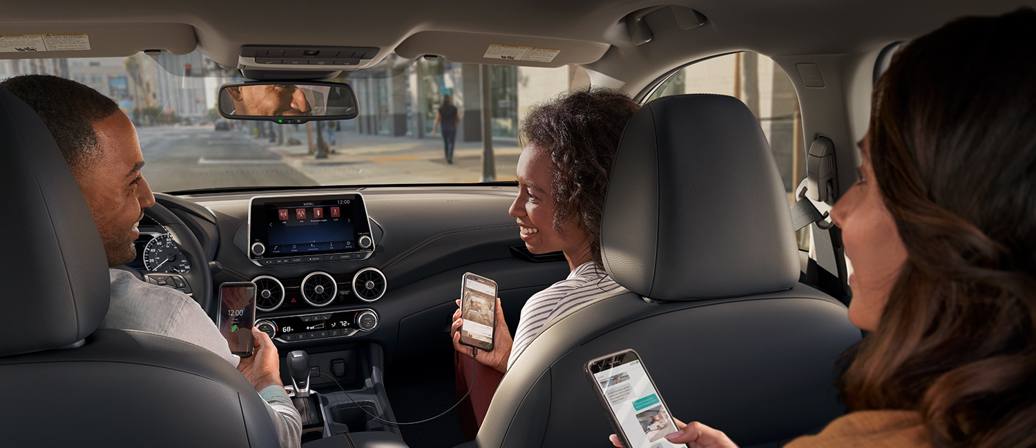 2022 Nissan Sentra Technology 2022 Nissan Sentra interior with people sitting connecting their smartphones
