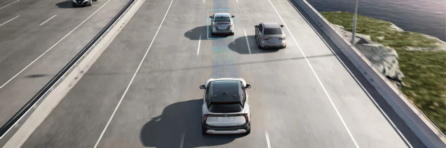2025 Nissan Rogue Safety Nissan Driving Down Road with Nissan Safety Features