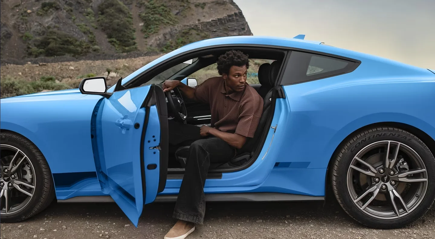 Man getting out of a 2024 Ford Mustang 