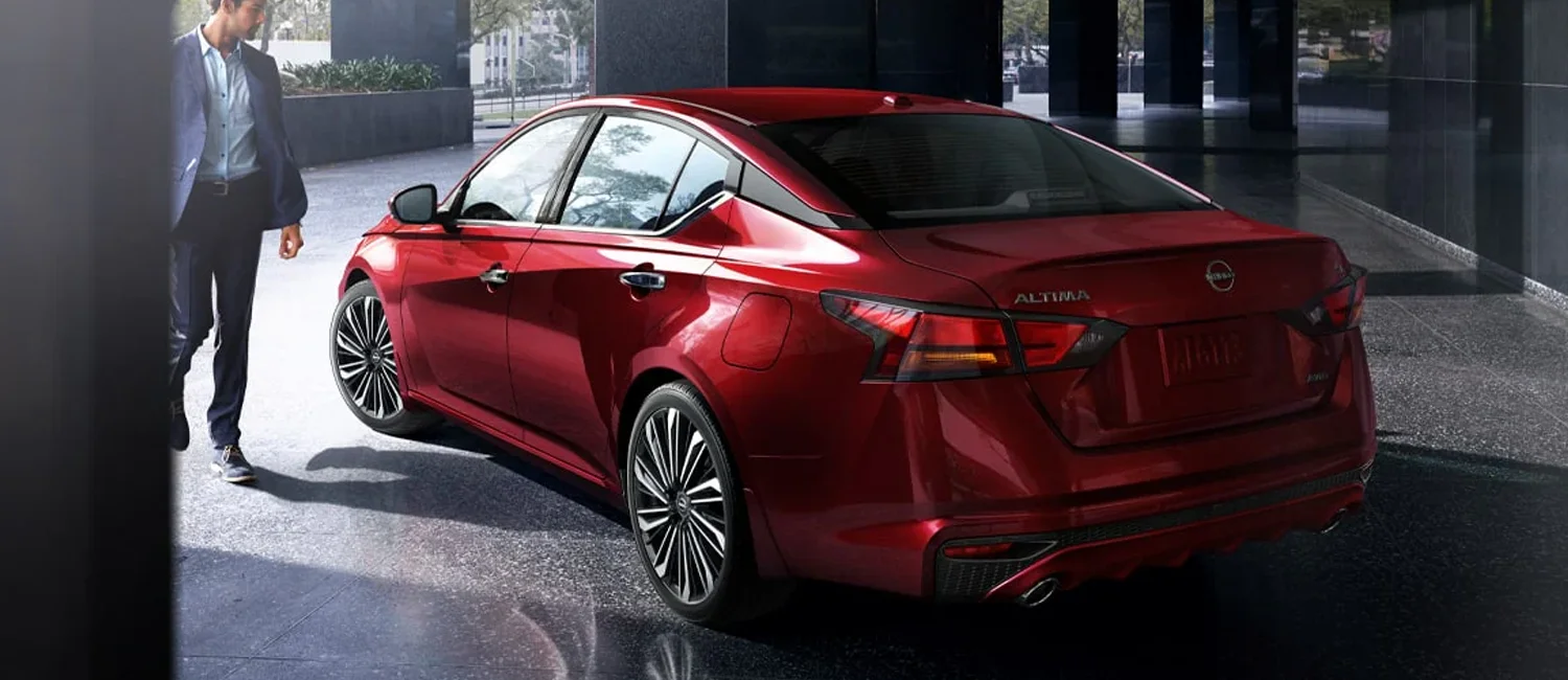  Man walking up to a 2024 Nissan Altima