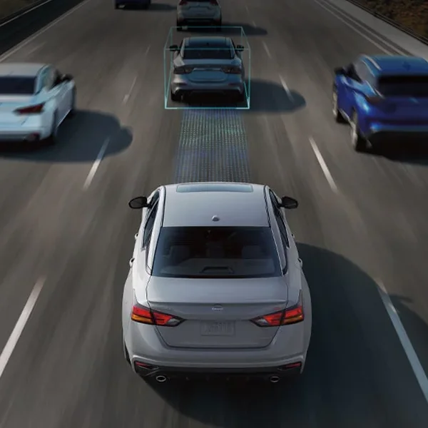 2024 Nissan Altima driving down road showing safety features