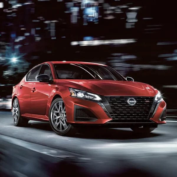 2024 Nissan Altima driving down a city street