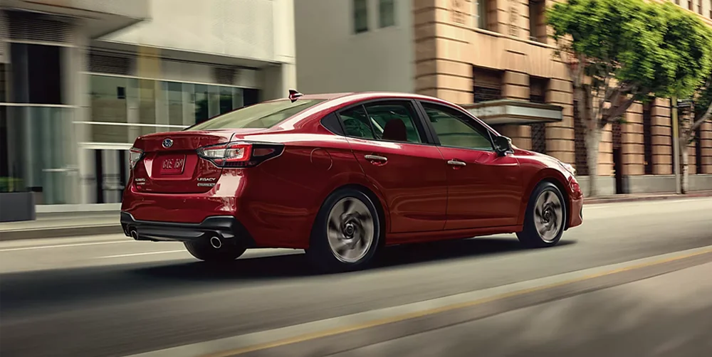 Subaru Legacy driving down road