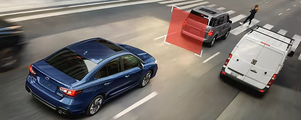 A blue Subaru Legacy projects a grid onto traffic representing EyeSight Driver Assist Technology.