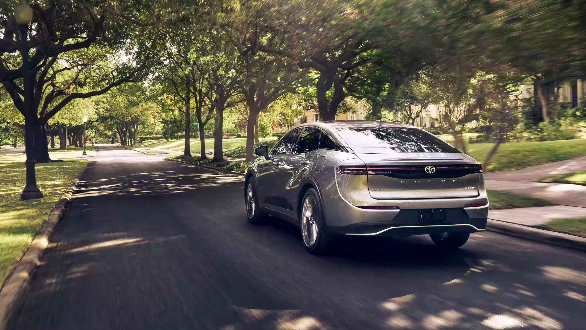 Two 2023 Toyota Crown driving on suburban road